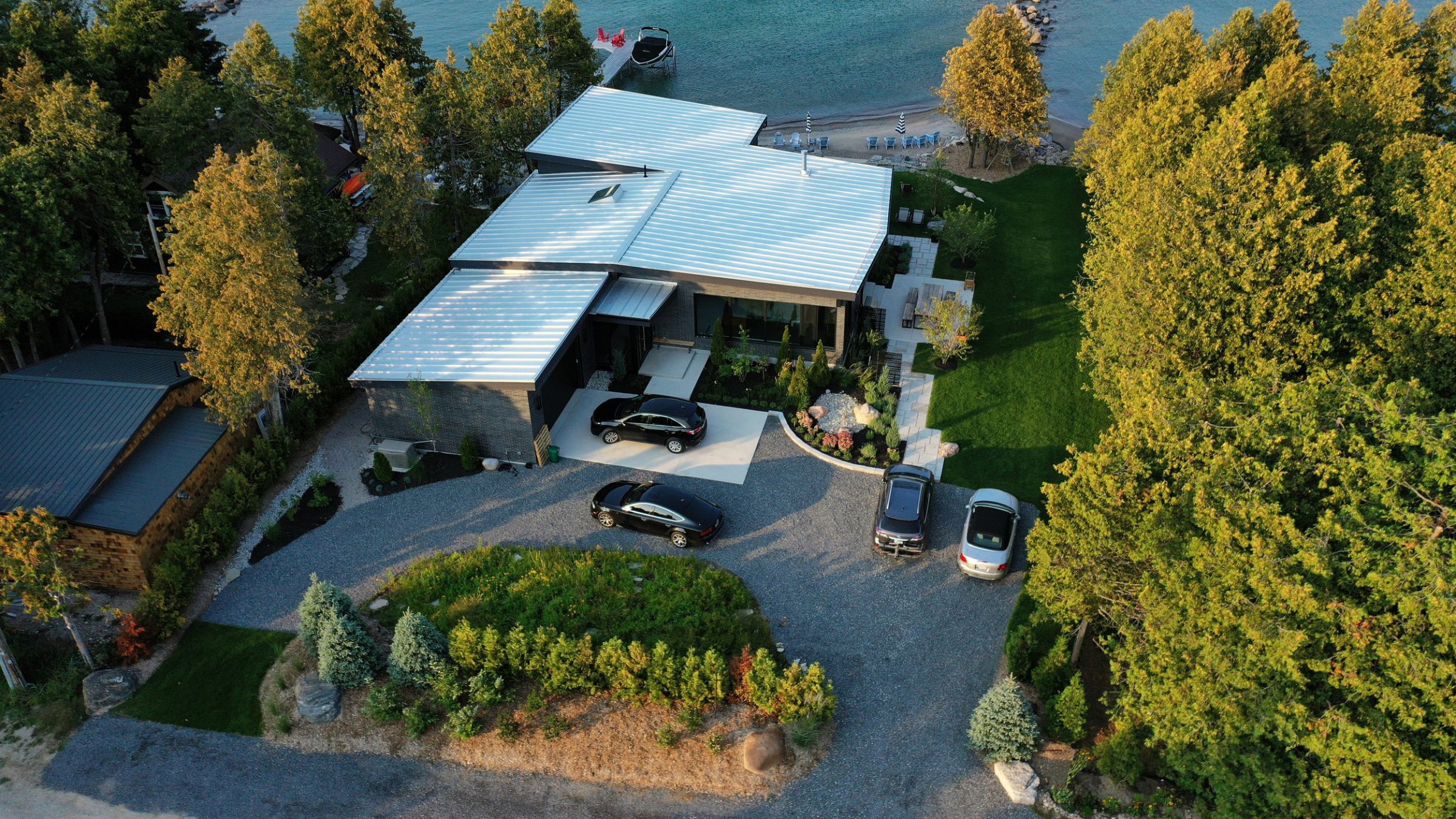Aerial view of modern lakeside home and dock