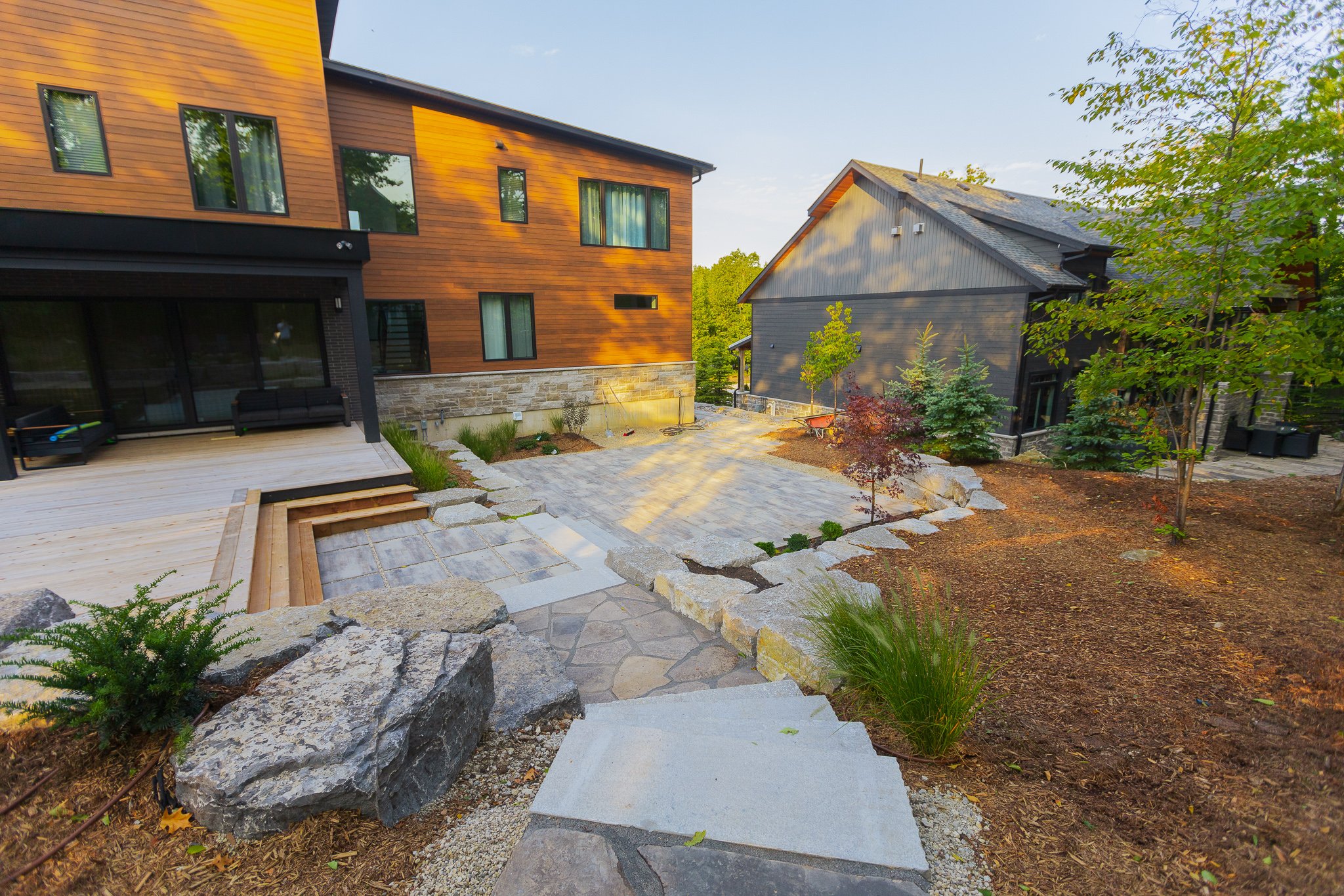 Modern backyard with deck and stone patio