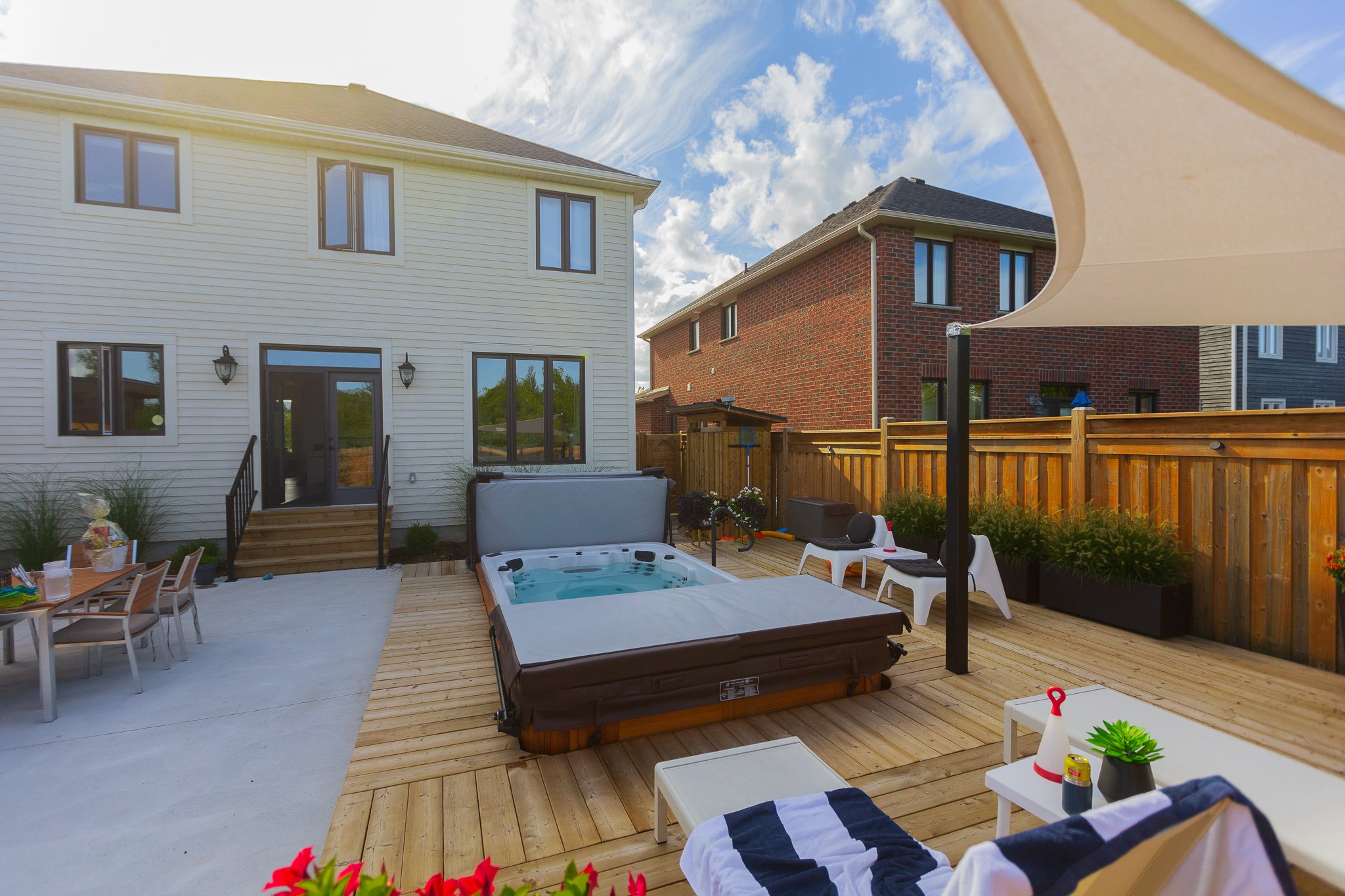 Backyard deck with hot tub and lounge chairs