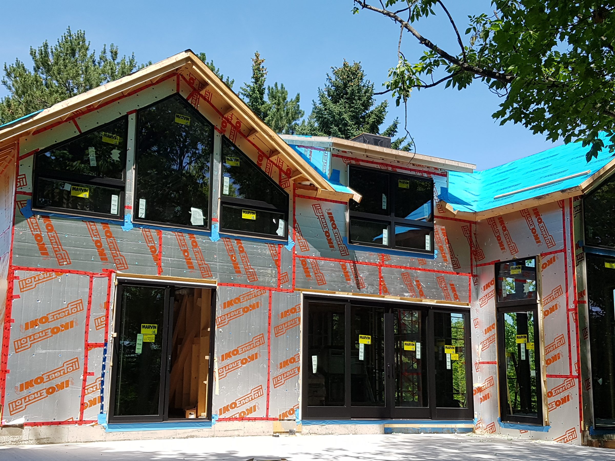 Modern house under construction with large windows
