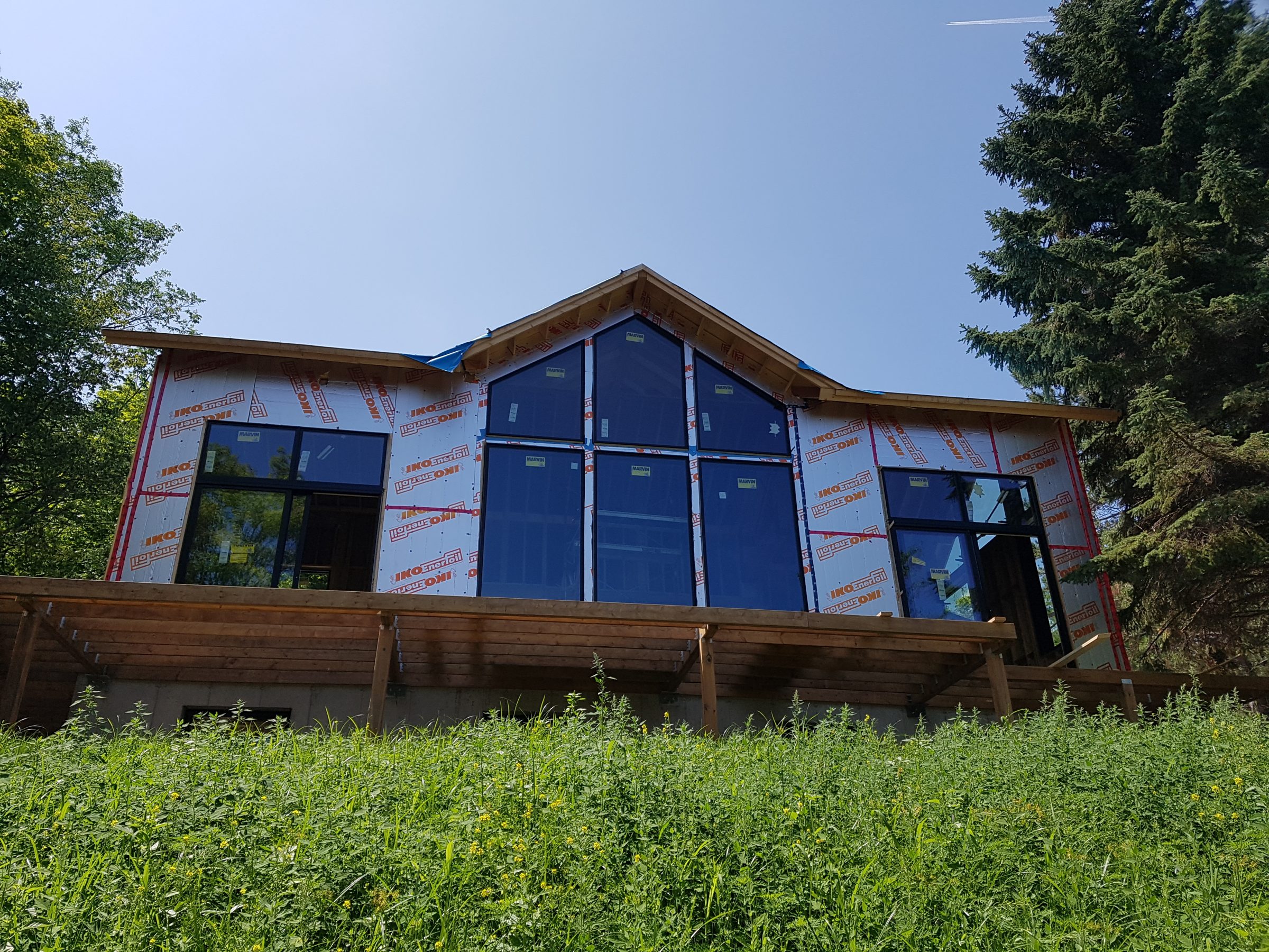 Modern house under construction with large windows