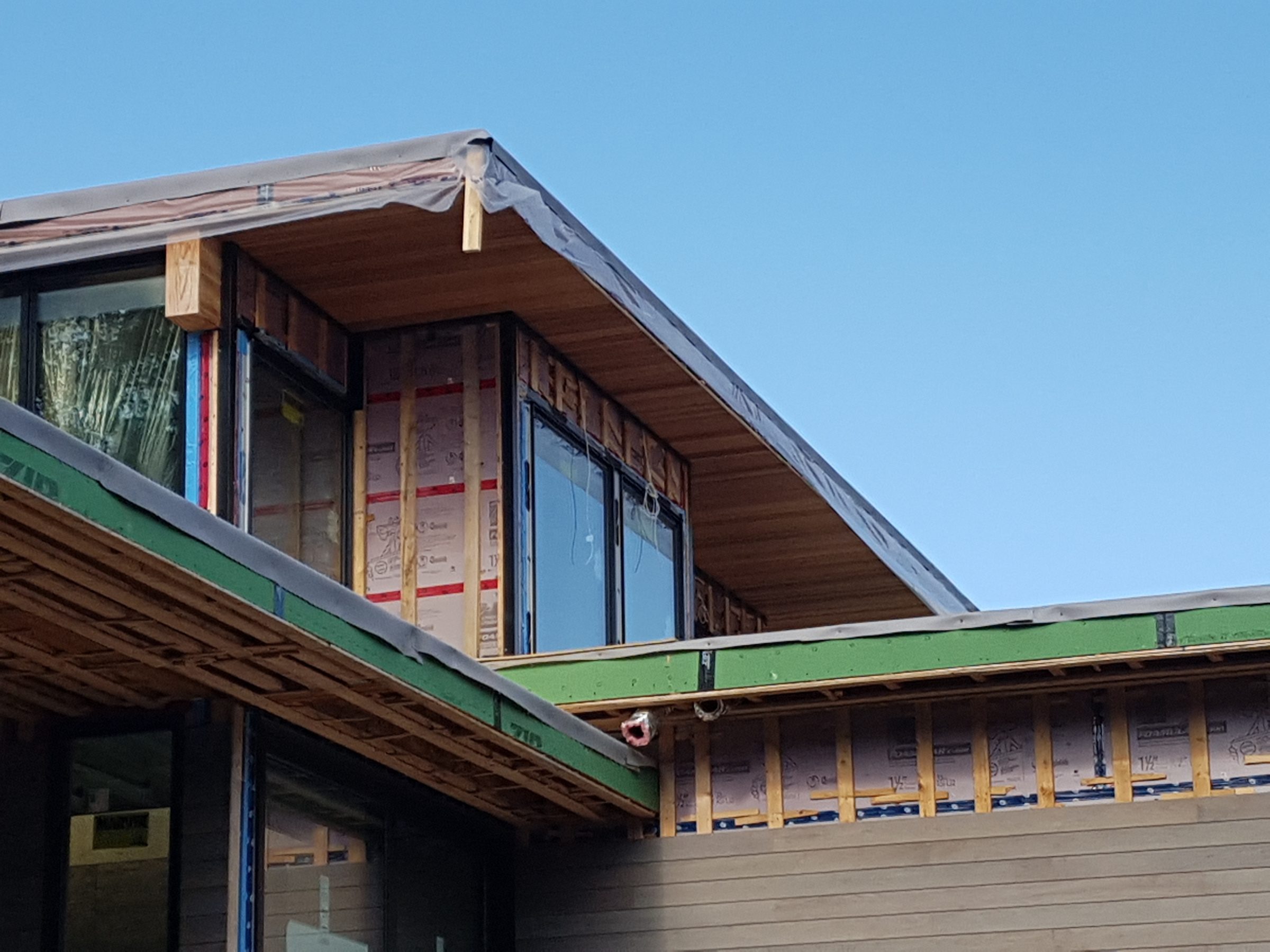Modern house under construction with exposed framing
