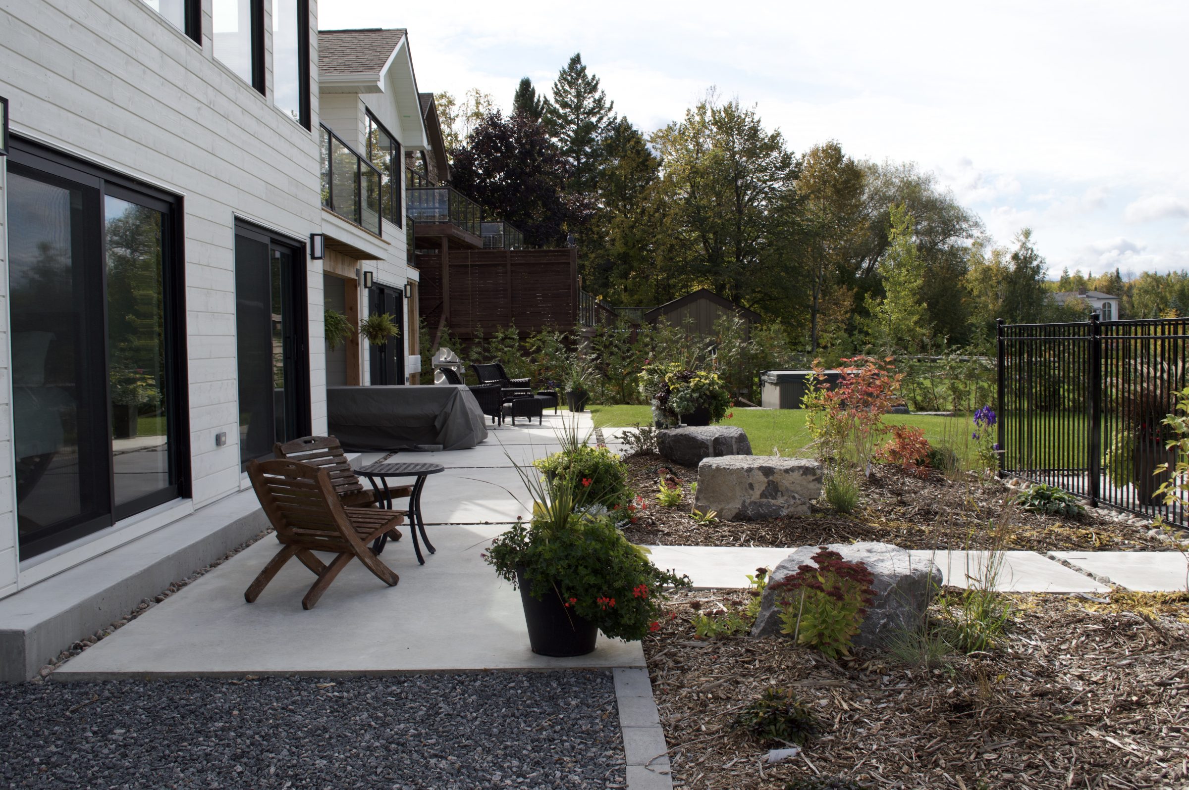 Modern backyard patio with landscaped garden and seating