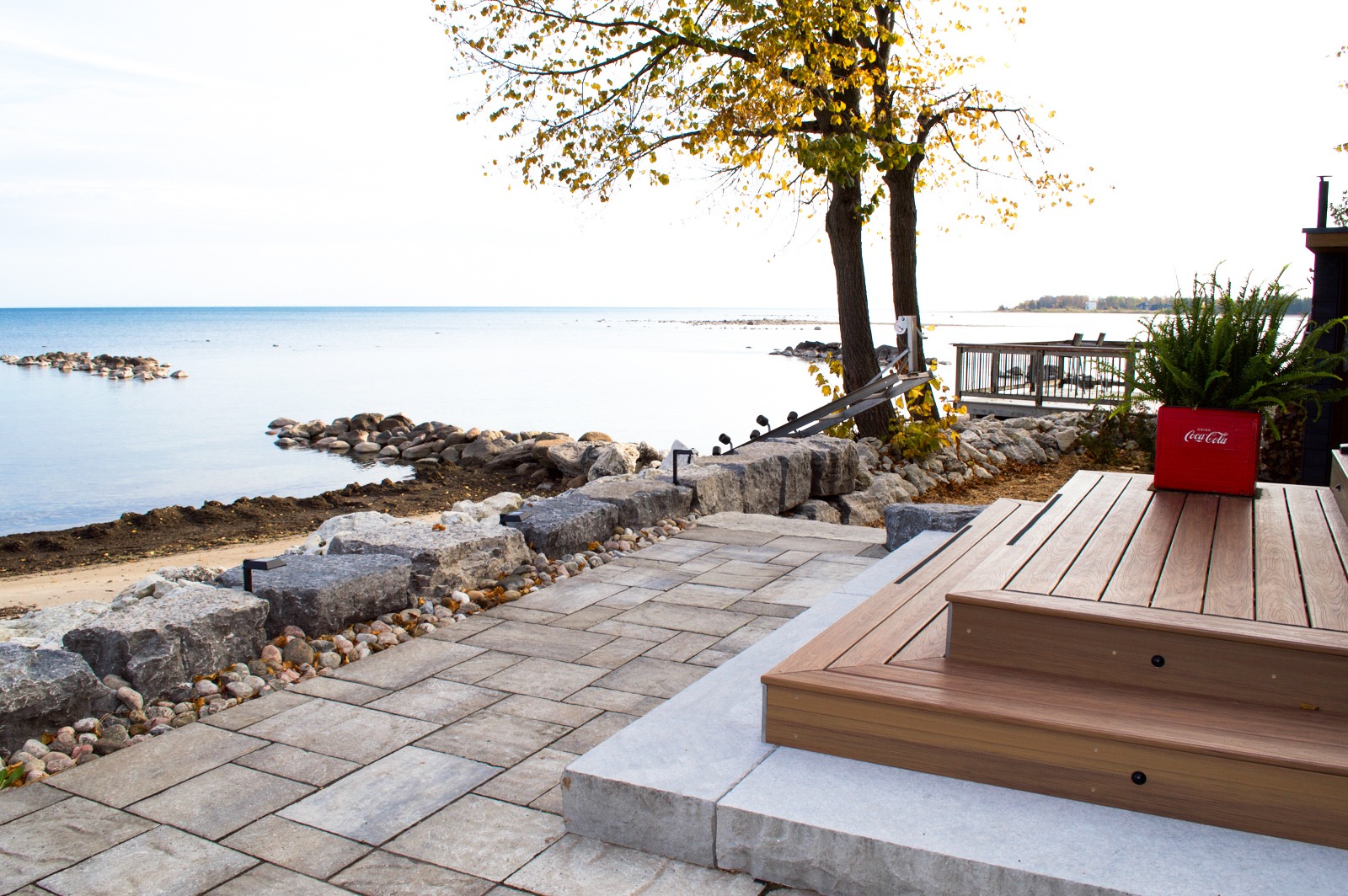 Lakeside patio with stone walkway and wooden steps
