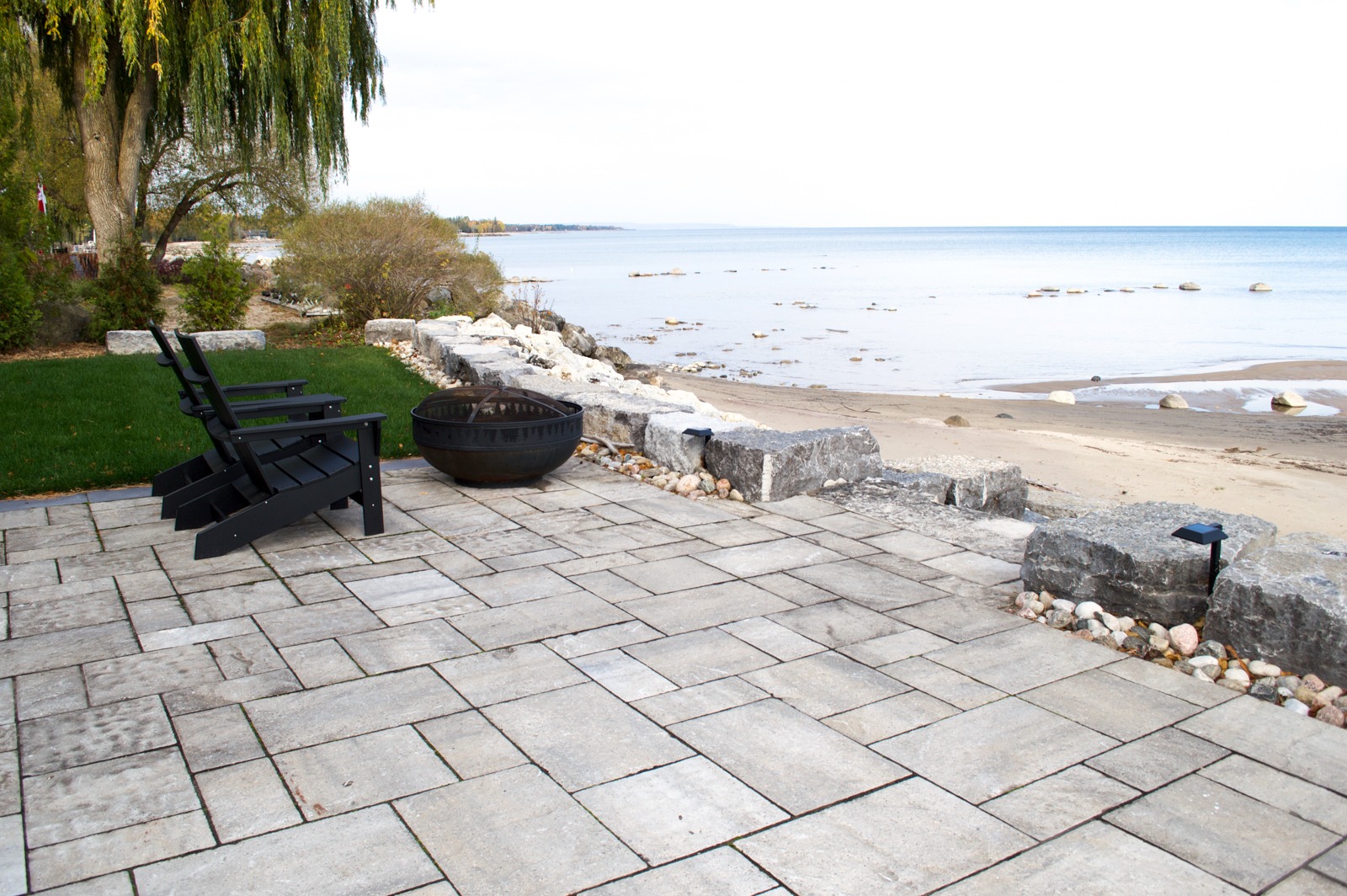 Lakeside patio with chairs and fire pit