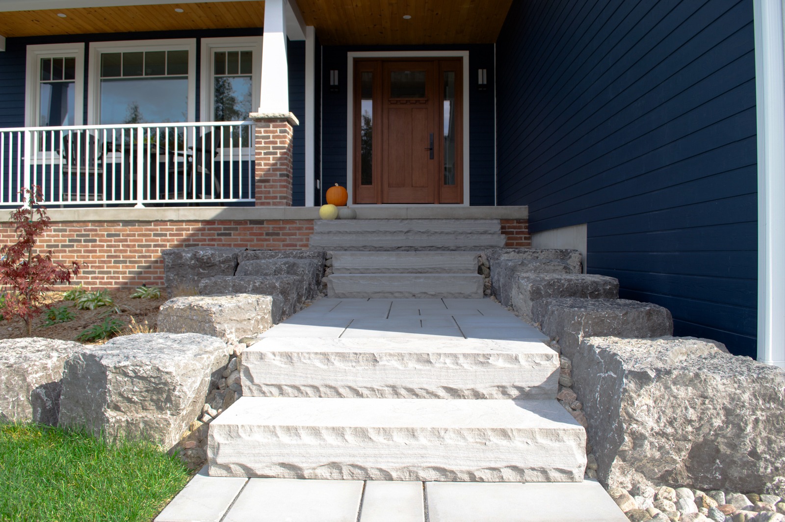 Stone steps leading to blue house porch