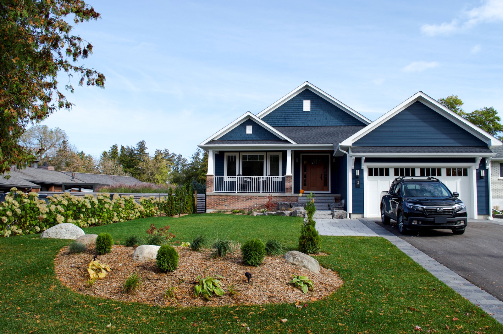 Blue suburban home with porch and driveway