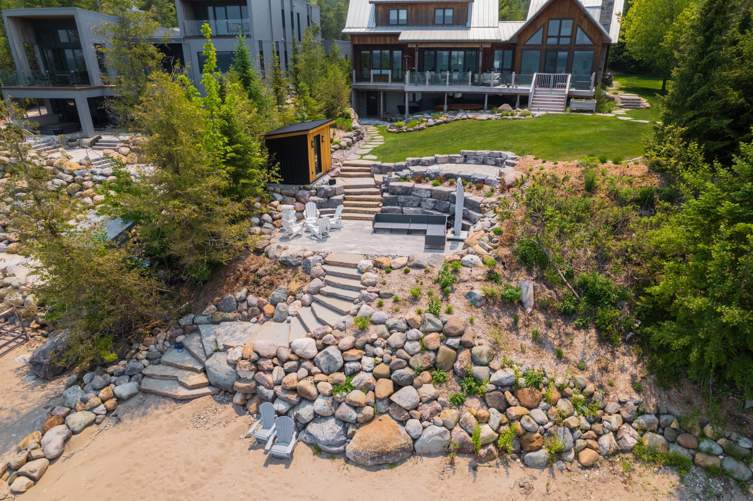 Terraced lakeside backyard with stone steps and patio