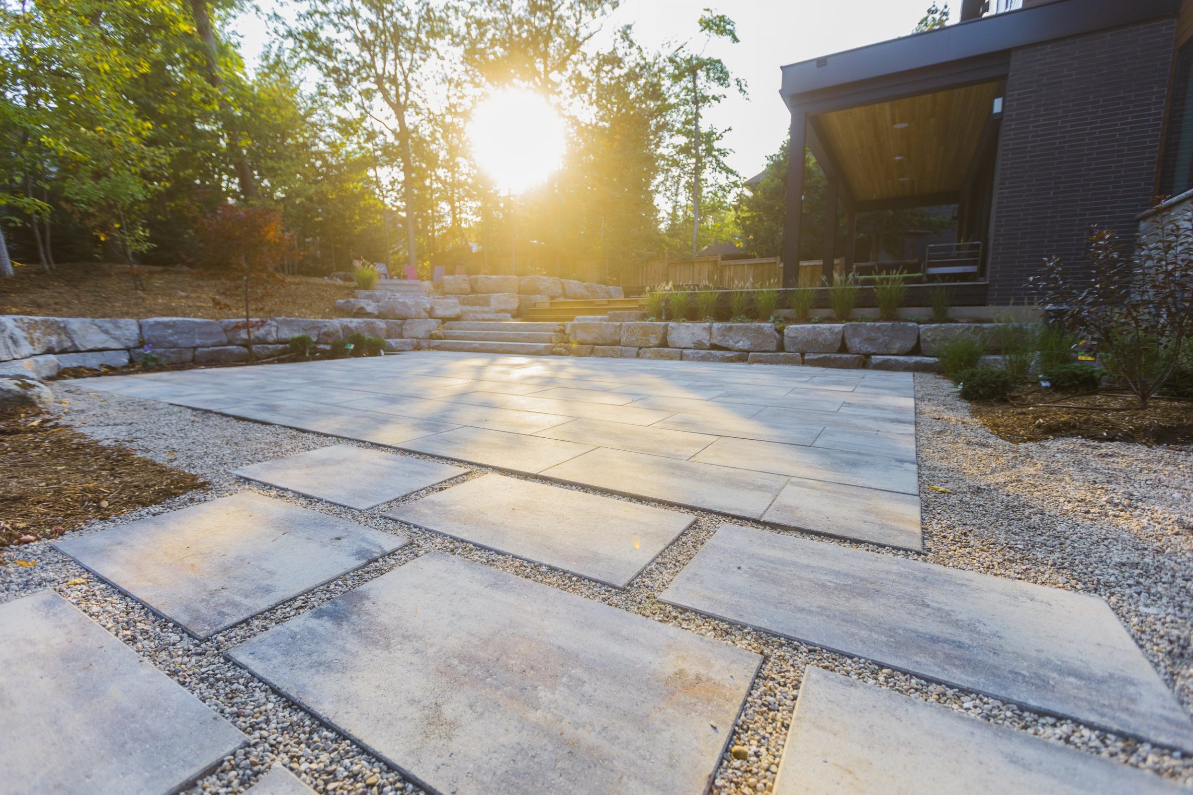 Modern backyard patio with stone steps at sunset