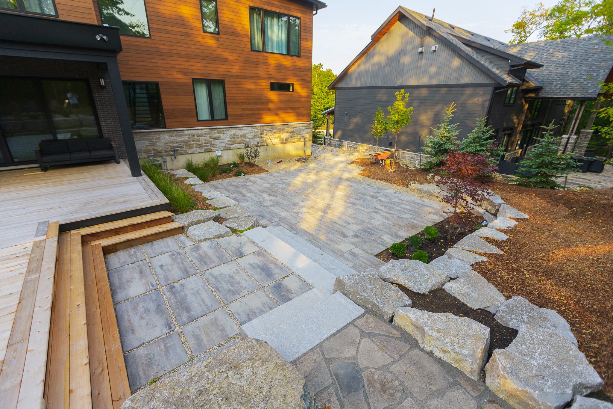 Modern backyard patio with deck and landscaping