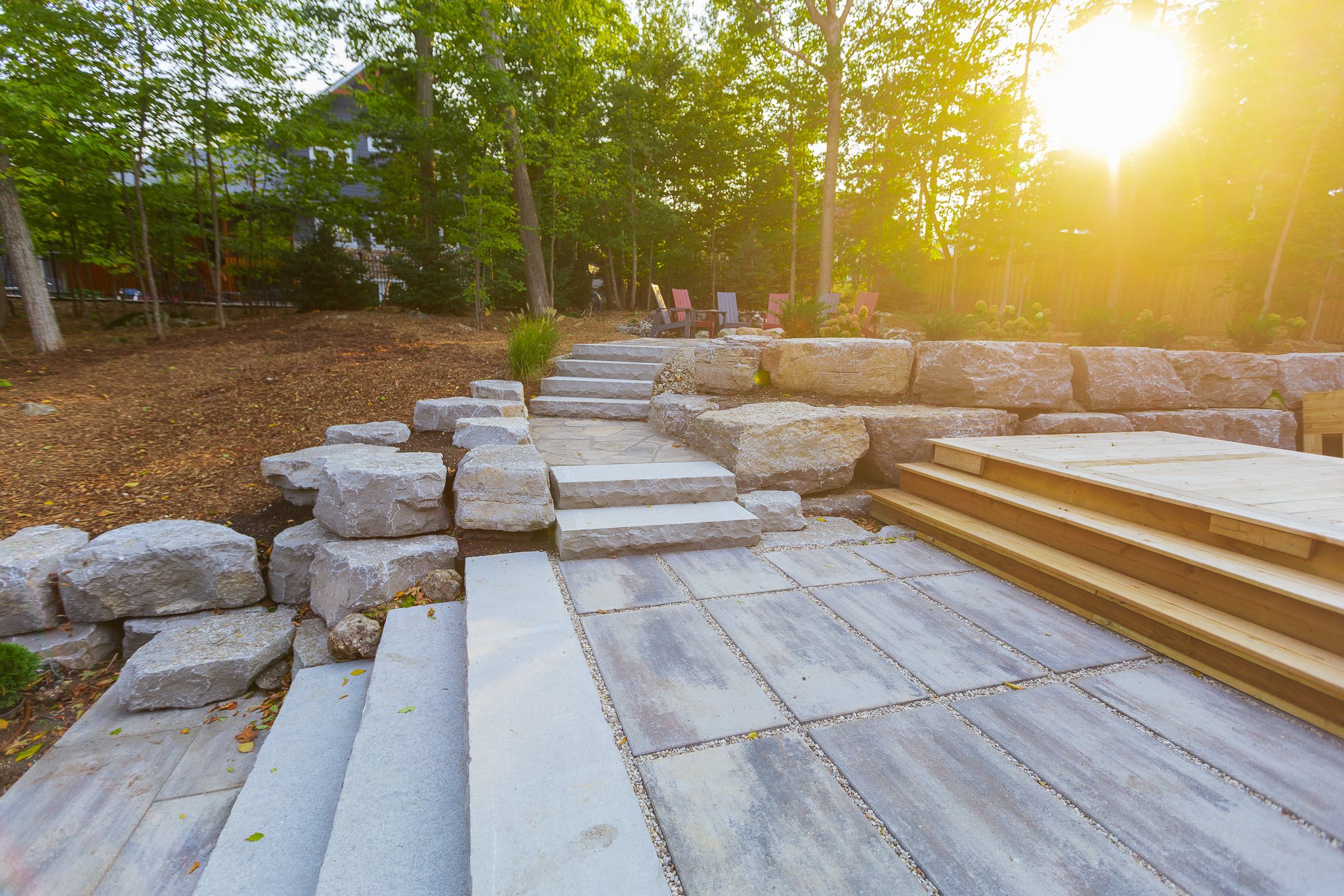 Stone patio steps and terraced backyard at sunset