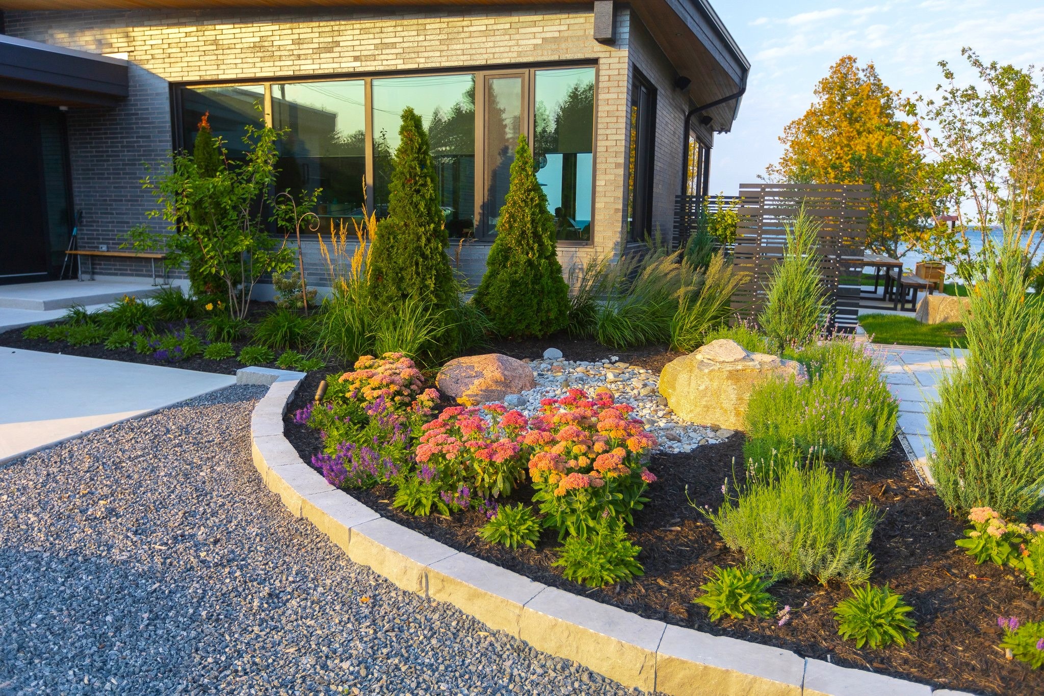 Modern home with landscaped garden and stone border
