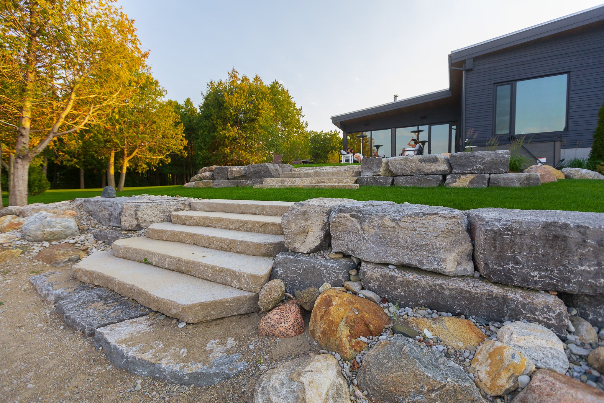 Modern home with stone steps and landscaped yard