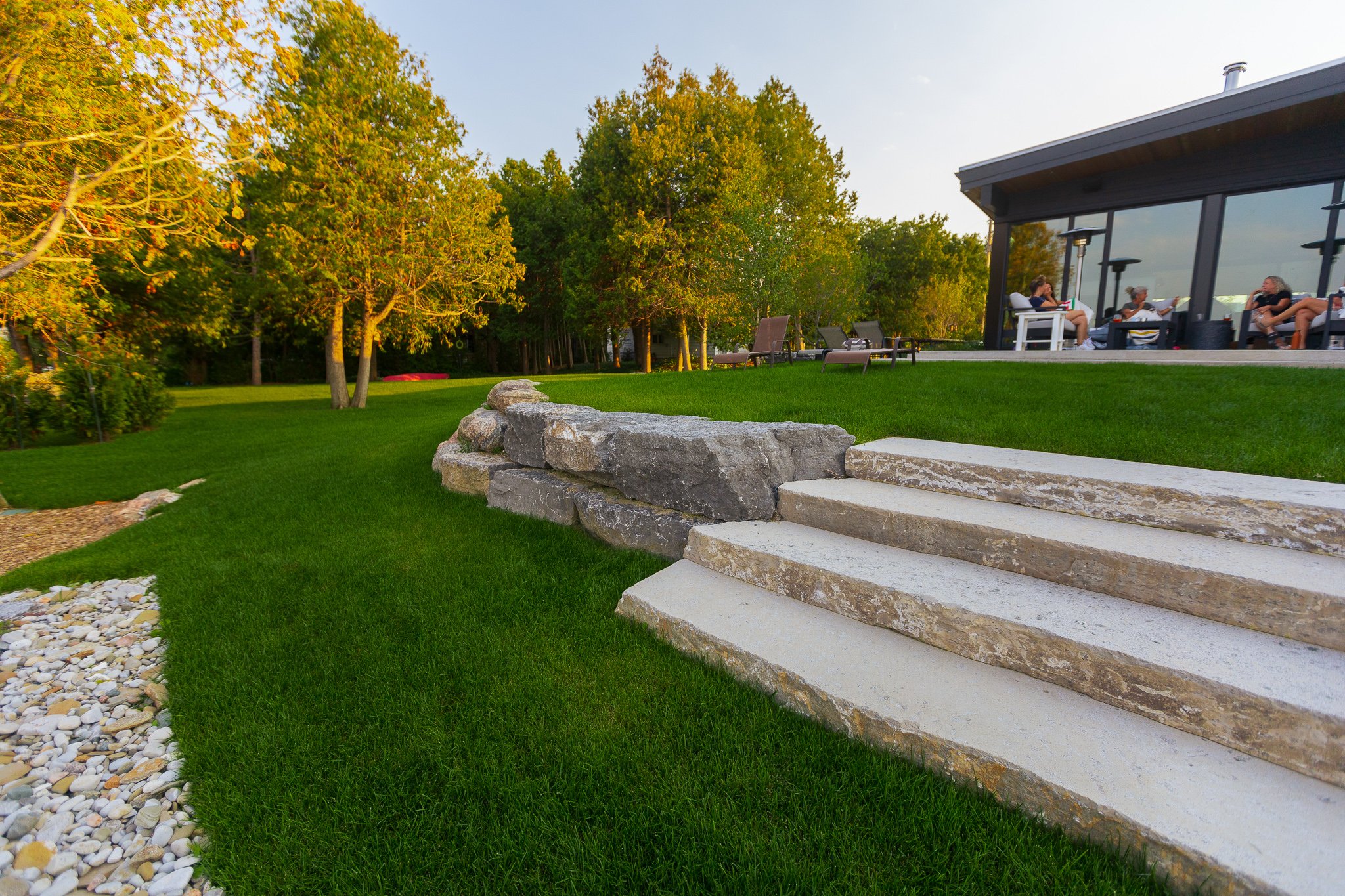 Modern backyard with stone steps and patio seating