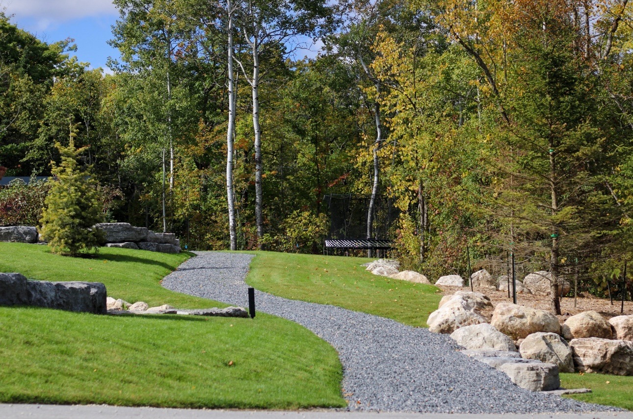 Gravel path through landscaped garden with trees