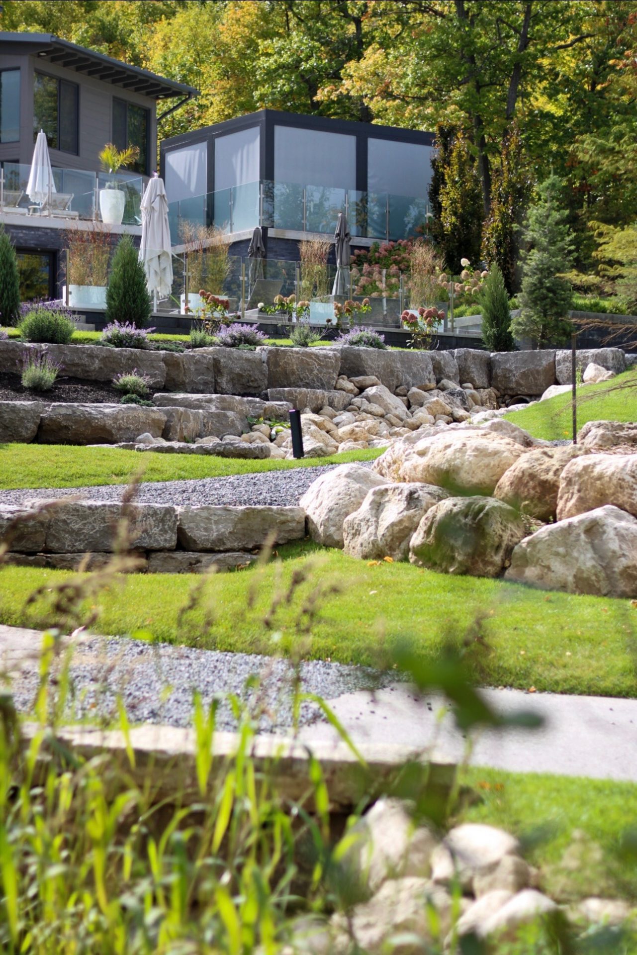 Modern home with landscaped terraced rock garden