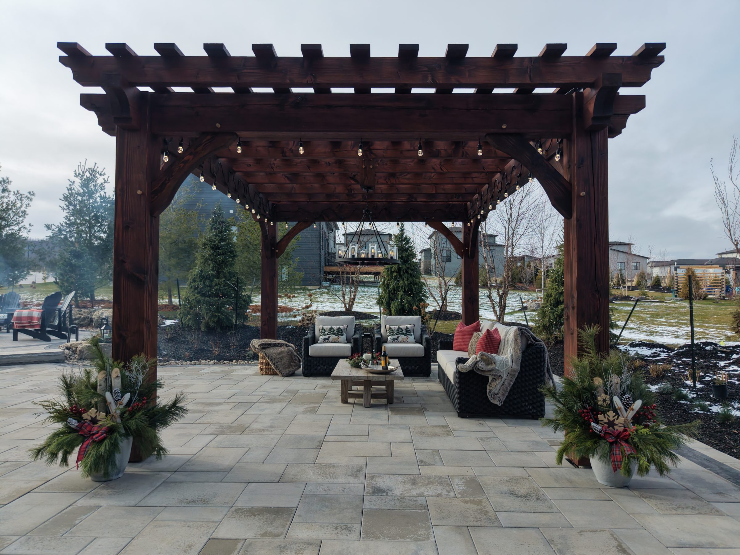 Wooden pergola over cozy backyard patio seating