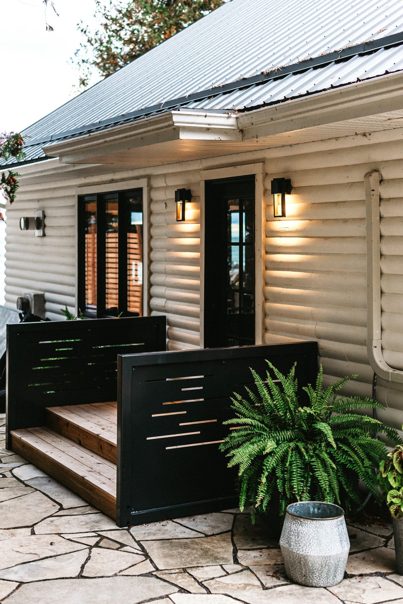 Cozy cabin exterior with lit wall sconces