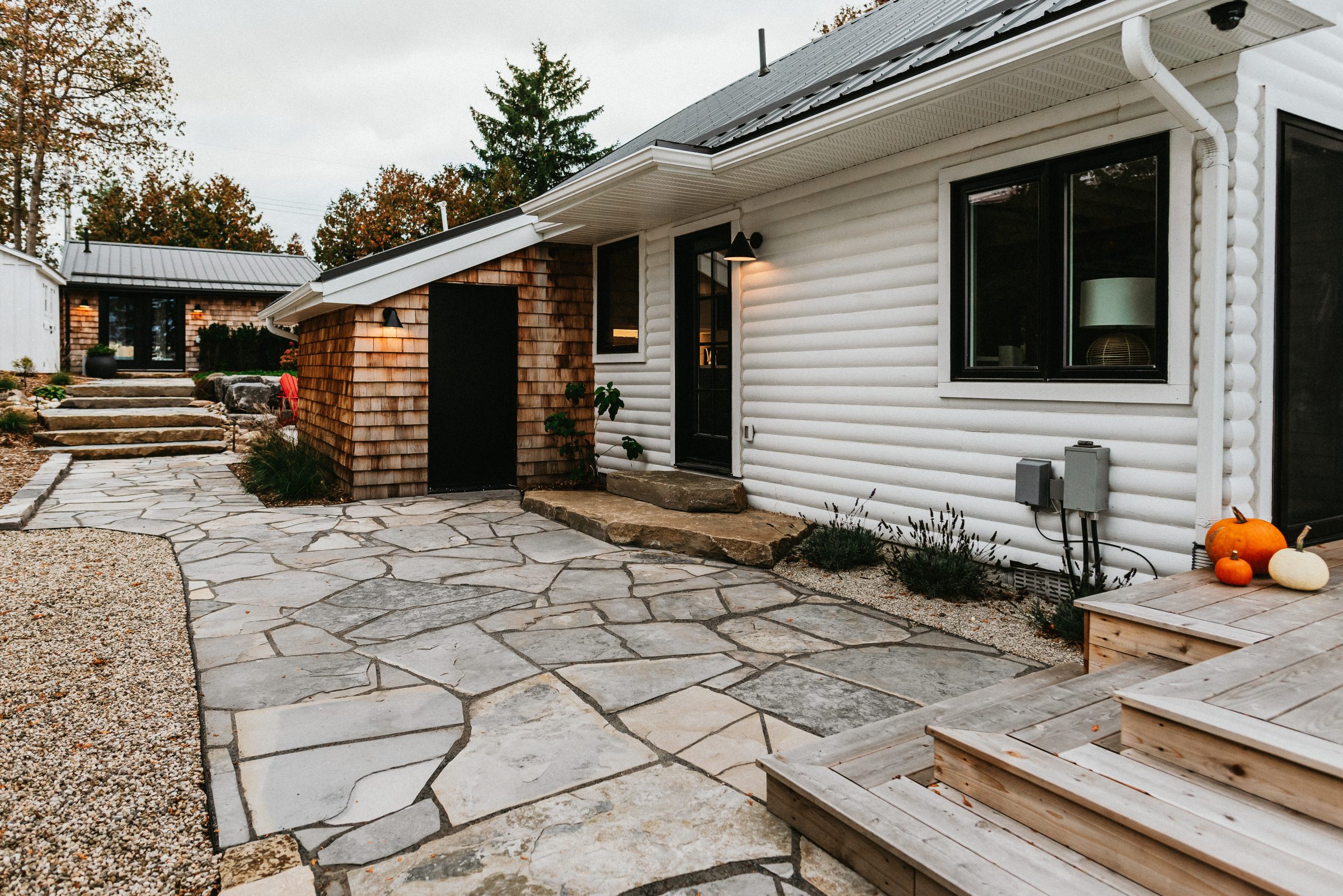 Modern rustic home exterior with stone patio