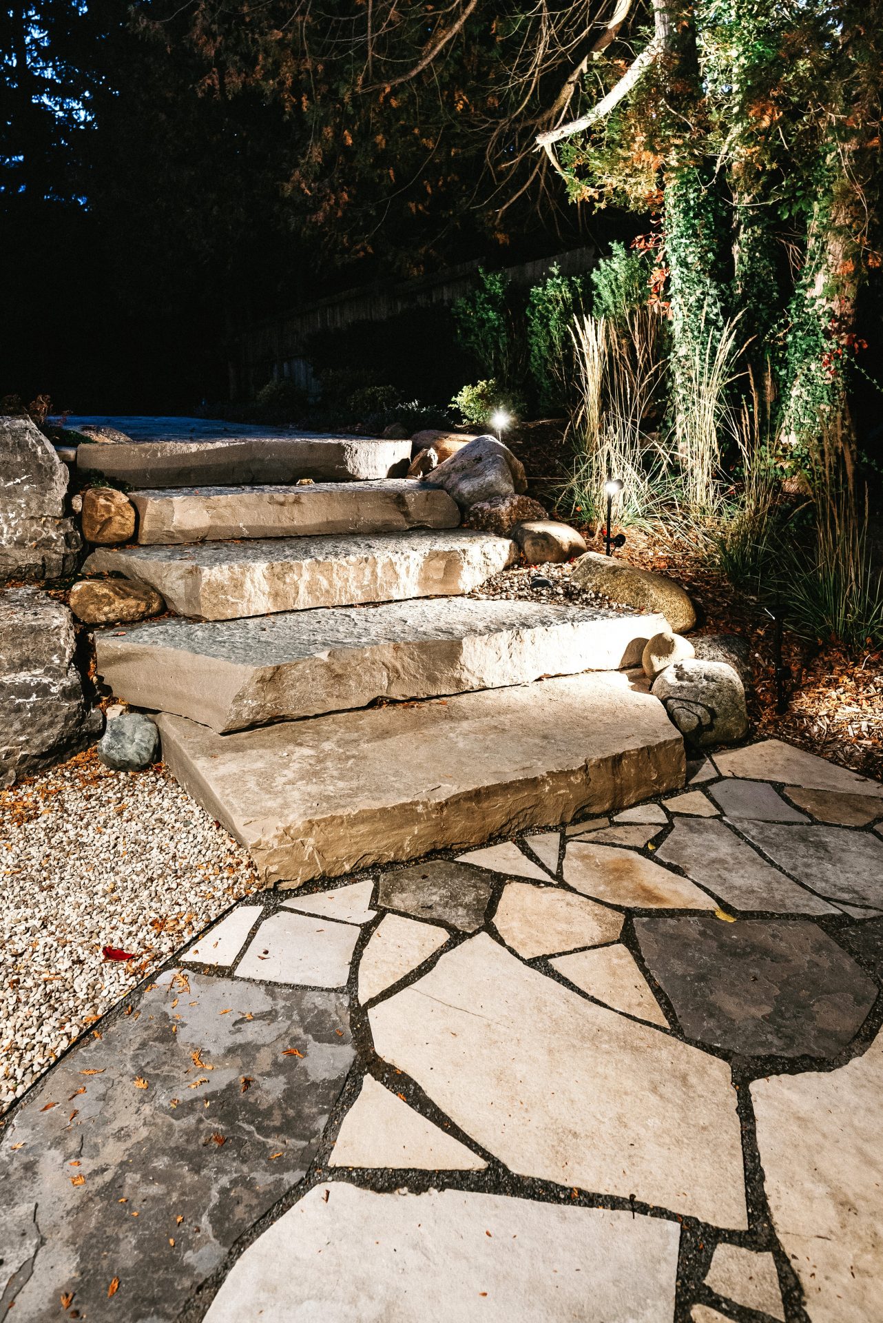 Illuminated stone garden steps at night