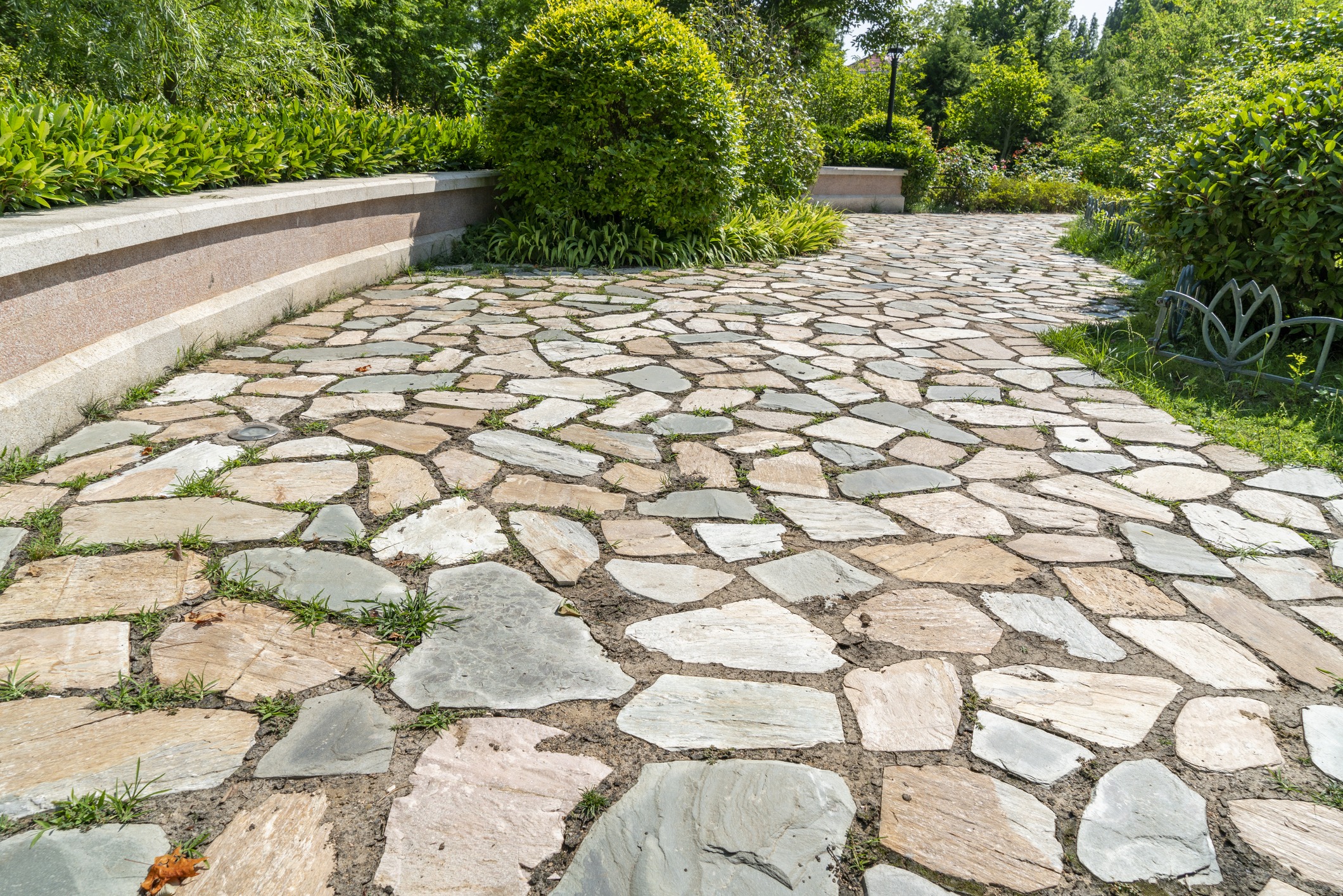 Stone pathway through lush landscaped garden