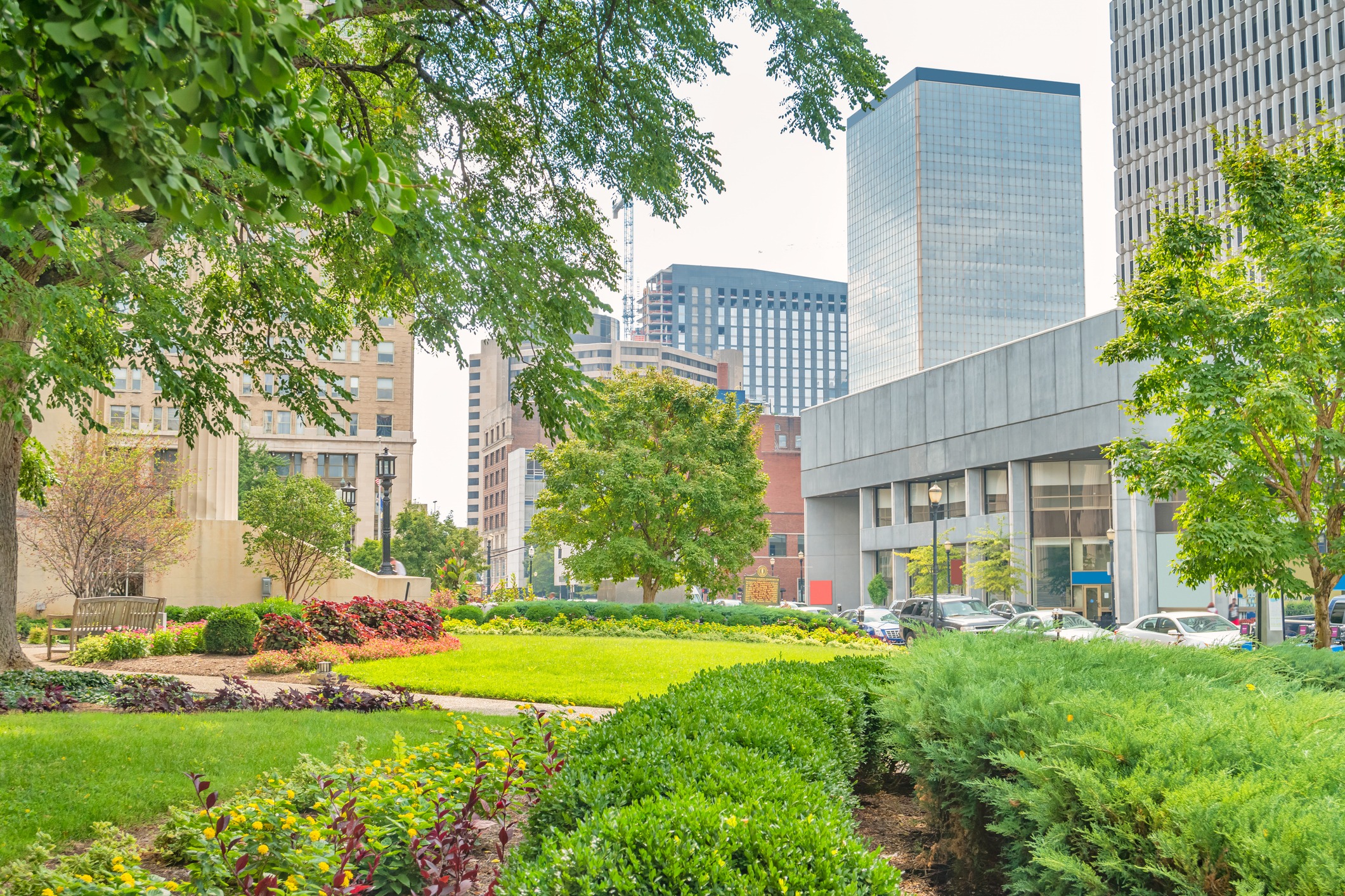 Urban park with gardens and city skyscrapers