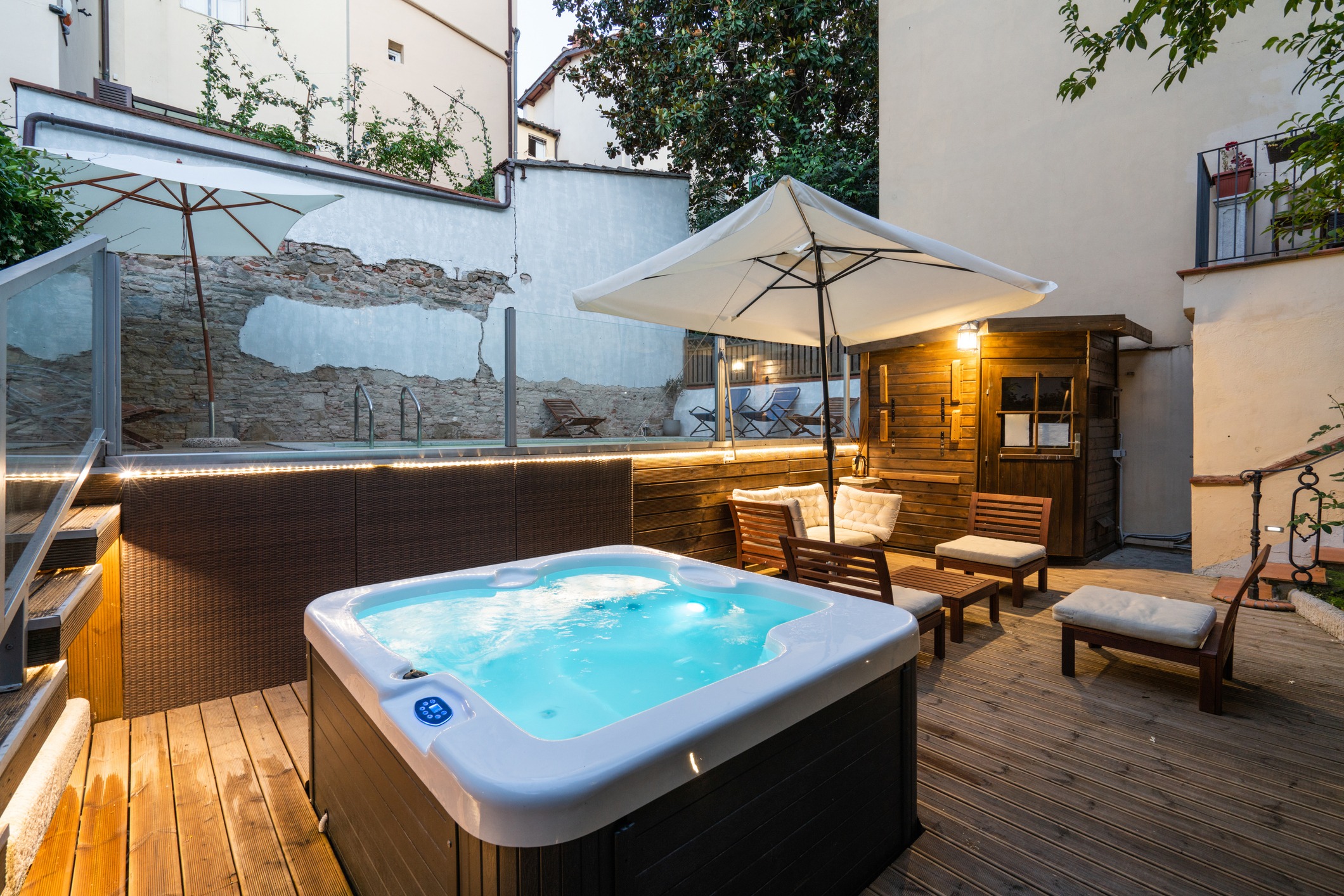 Cozy outdoor patio with hot tub and seating