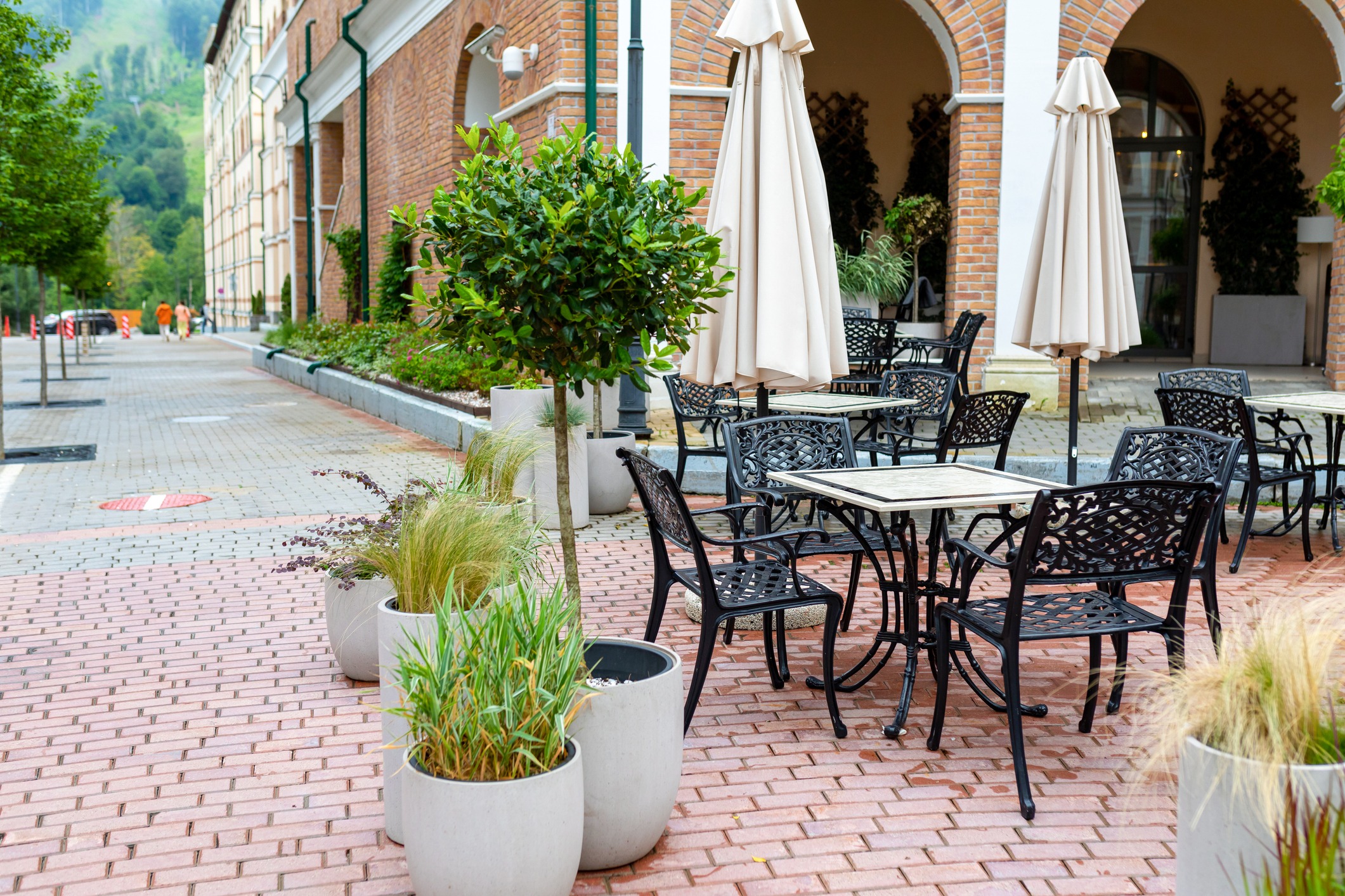 Outdoor café seating along brick building walkway