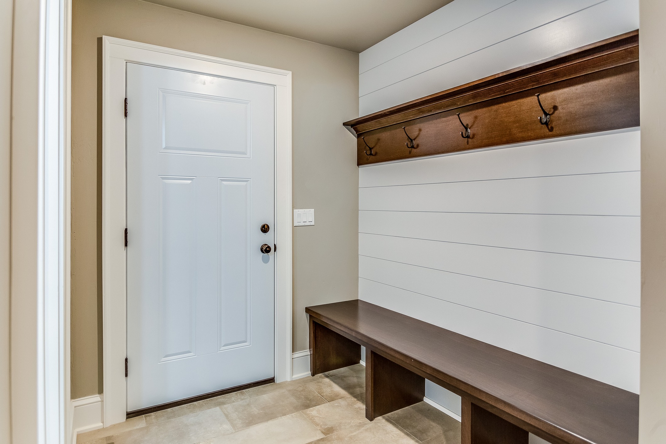 Mudroom entryway with bench and wall hooks