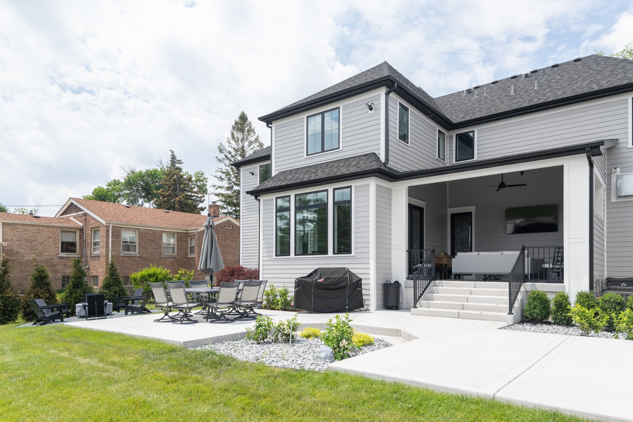 Modern two-story home with backyard patio and porch