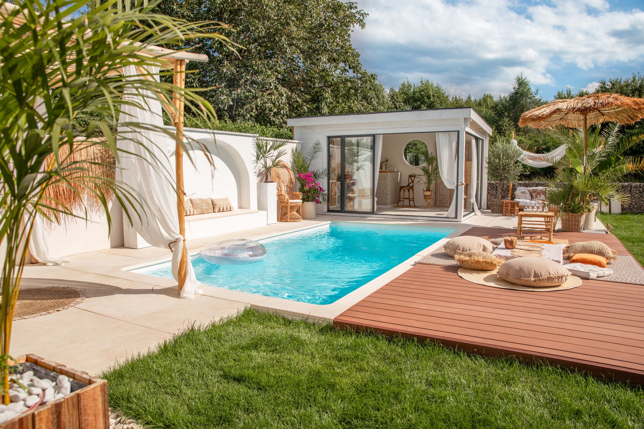 Modern backyard pool with cabana and lounge deck