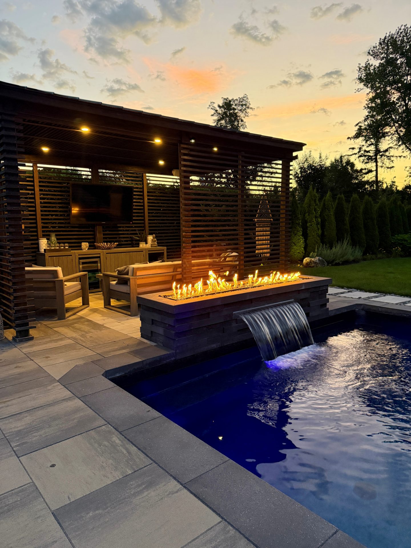 Modern backyard patio with fire feature and pool