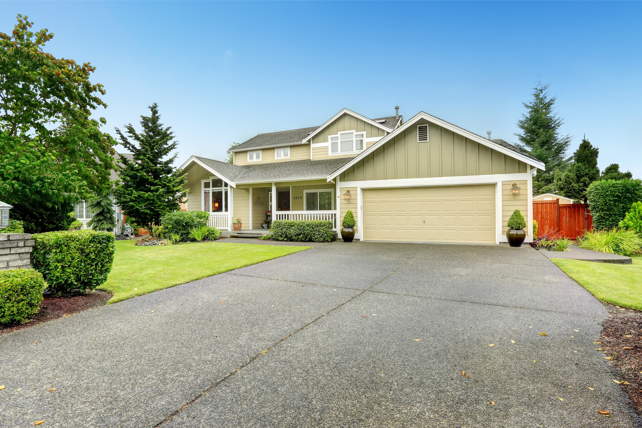 Two-story suburban home with double garage and lawn